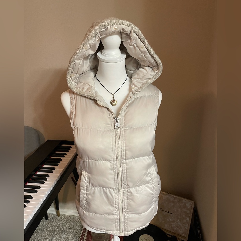 Super light gray ish cream puffer vest with hood and knit on the back.